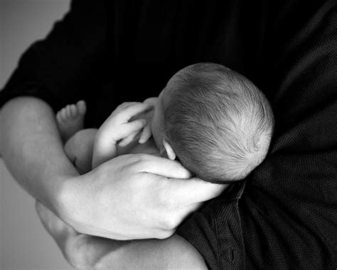 The Symbolic Significance of a Man Cradling an Infant Male